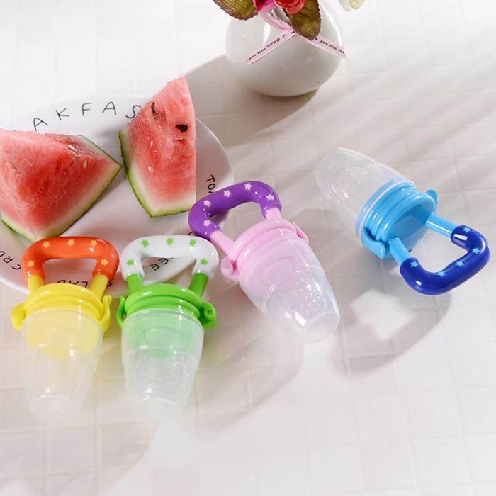 Adorable baby happily using a fruit-shaped teether pacifier, soothing natural flavors.