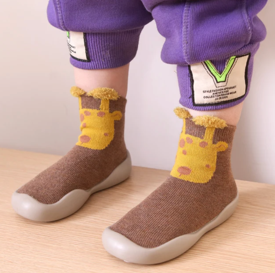 Adorable baby wearing soft, non-slip crib booties.  Safe and comfy for crawling.  Perfect baby shower gift!