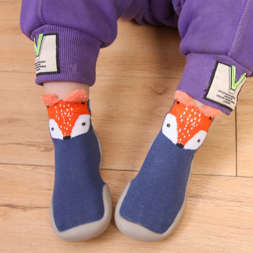 Adorable baby wearing soft, non-slip crib shoes.  Safe & comfy booties for crawling & playtime.  Perfect baby shower gift!
