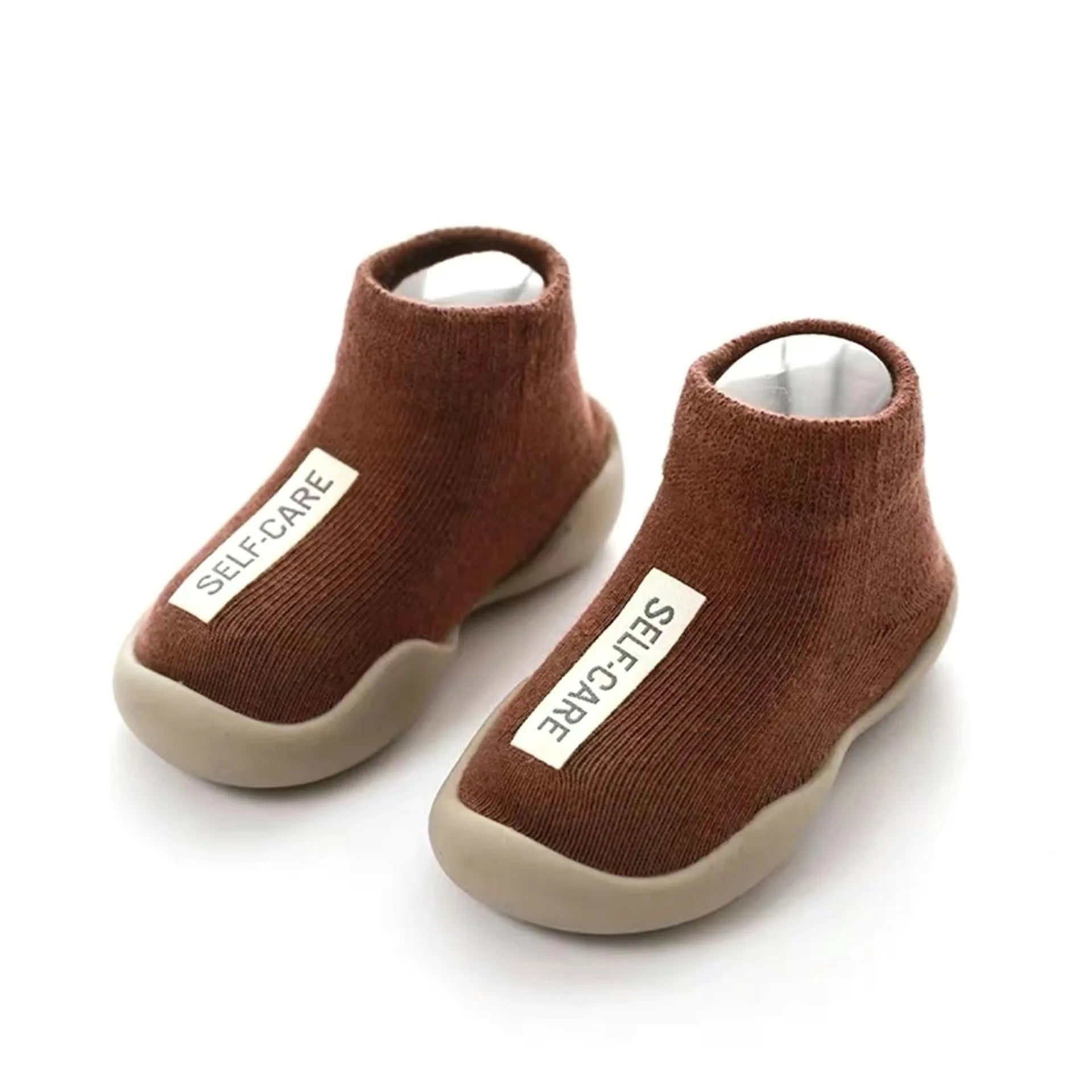Adorable close-up of non-slip baby crib shoes.  Soft, safe booties for crawling babies.  Perfect for indoor play!
